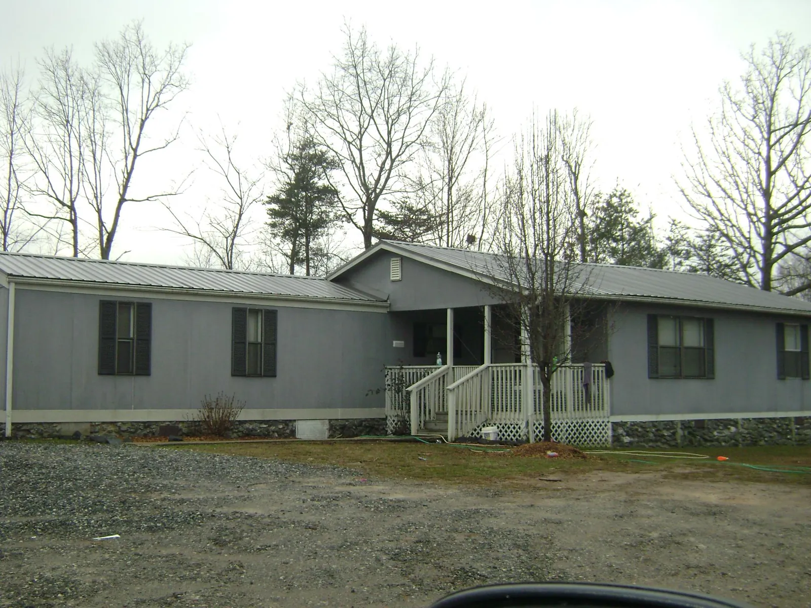 Metal roof over a manufactured home with a covered front porch in Pinon Hills