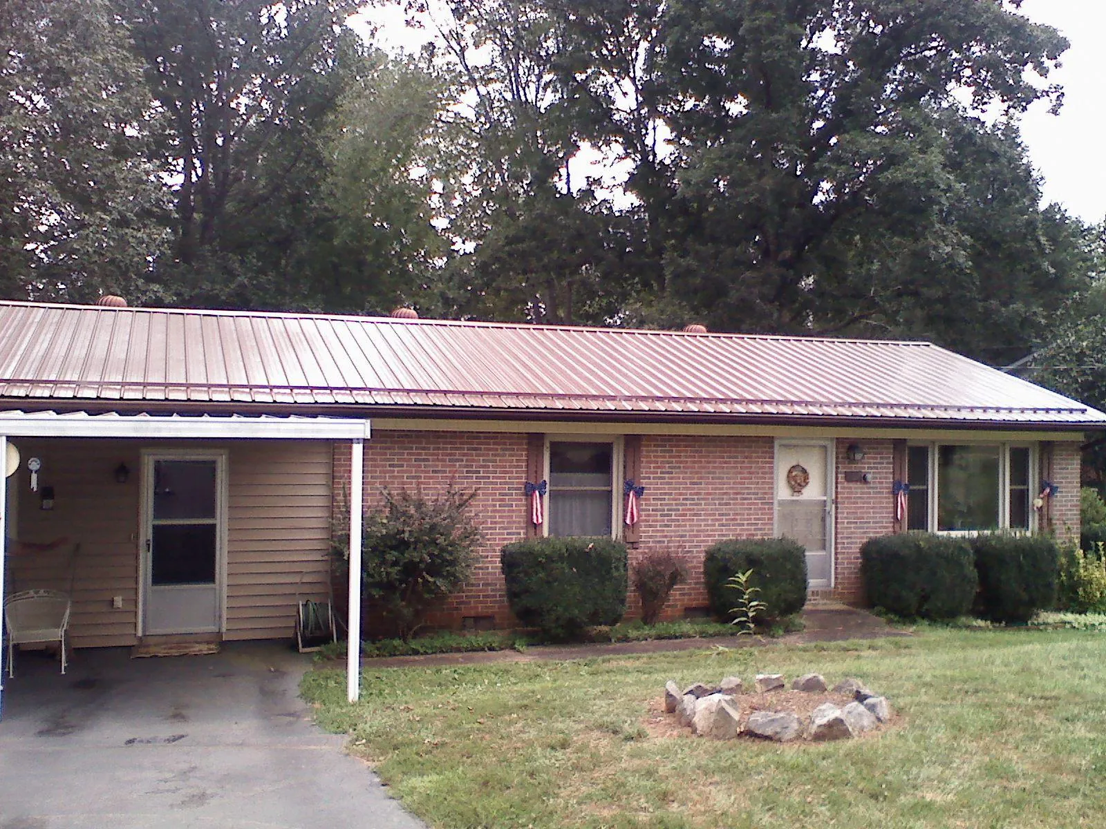 Bronze metal roof and carport on a brick ranch home — Roof Repair work by our crew in Pinon Hills